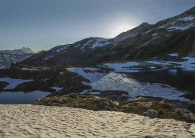 Icy lake and mountain snow in late afternoon