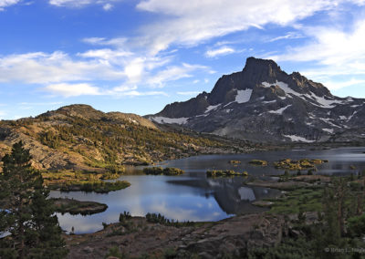 Afternoon light illuminates lake and peaks