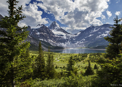 Alpine view of mountain peak with clouds