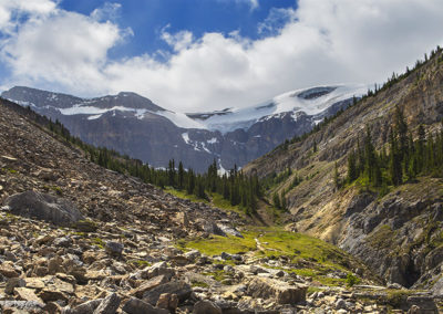 Meadow and mountain views under encroaching clouds