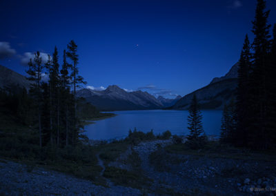 Night lake under deep blue skies