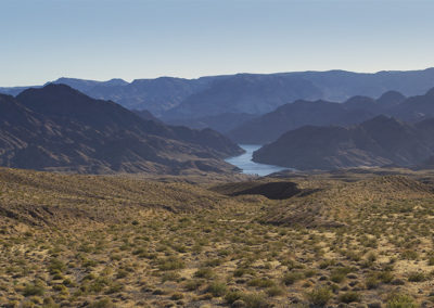 Broad river cuts through desert canyon