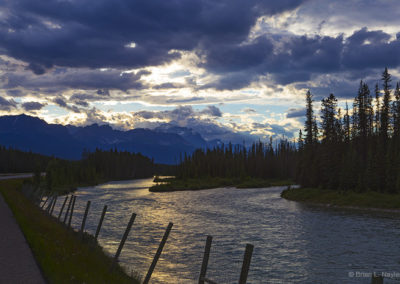 Riverside view under threatening clouds in evening light