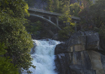 Arch bridge waterfalls in spring flow