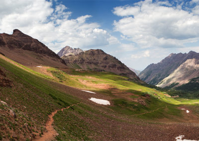 Scattered light lines the mountains and valleys ahead.